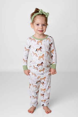 Girl wearing bamboo pajamas for toddlers and kids in Perfect Ponies print