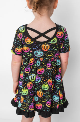 Bamboo ruffle dress for toddlers and kids in glowing neon Halloween Pumpkins print 